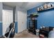 Carpeted bedroom featuring a closet, mounted shelves and blue accent wall at 34734 N Happy Jack Dr, San Tan Valley, AZ 85144