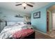 A bedroom with a bed, dresser, wall decorations and a ceiling fan at 34734 N Happy Jack Dr, San Tan Valley, AZ 85144