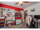 A crafting room featuring a red accent wall, storage and a work space at 34734 N Happy Jack Dr, San Tan Valley, AZ 85144