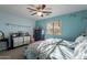 Cozy bedroom with a ceiling fan, a large window, and light blue walls at 34734 N Happy Jack Dr, San Tan Valley, AZ 85144