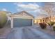 Charming single-story home featuring a gray garage door, neutral exterior paint, and low-maintenance desert landscaping at 34734 N Happy Jack Dr, San Tan Valley, AZ 85144