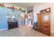 Living room featuring tile flooring, arched doorways, blue accent wall, and decorative shelving at 34734 N Happy Jack Dr, San Tan Valley, AZ 85144