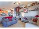 Open-concept living room featuring tile floors, neutral color palette, and decorative accents at 34734 N Happy Jack Dr, San Tan Valley, AZ 85144