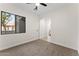 A bedroom with neutral carpet and a large window at 3557 S Halsted Ct, Chandler, AZ 85286