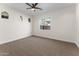 Bedroom features neutral carpet, ceiling fan and a window with outdoor views at 3557 S Halsted Ct, Chandler, AZ 85286