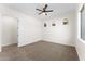 Bedroom features neutral carpet, ceiling fan, arched windows and white trim at 3557 S Halsted Ct, Chandler, AZ 85286