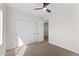 Bedroom with carpet flooring, neutral walls, and a closet with a modern ceiling fan at 3557 S Halsted Ct, Chandler, AZ 85286