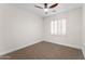 Neutral bedroom with a modern ceiling fan and window with bright natural light at 3557 S Halsted Ct, Chandler, AZ 85286