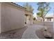 Home's arched and covered walkway leads to gated courtyard entrance at 3557 S Halsted Ct, Chandler, AZ 85286