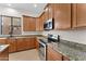 Close up of the kitchen featuring granite countertops and stainless appliances at 3557 S Halsted Ct, Chandler, AZ 85286