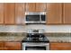 This stainless steel range and microwave are set in stunning granite countertops at 3557 S Halsted Ct, Chandler, AZ 85286