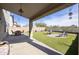 A lovely covered patio looks out onto an artificial turf backyard with outdoor seating at 4439 E Coyote Wash Dr, Cave Creek, AZ 85331