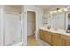 Well-lit bathroom featuring double sink vanity, neutral paint, stand up shower, and tile flooring at 4439 E Coyote Wash Dr, Cave Creek, AZ 85331