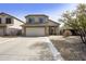 Charming two-story home featuring a spacious driveway and low-maintenance desert landscaping at 4439 E Coyote Wash Dr, Cave Creek, AZ 85331