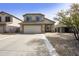 Charming two-story home with a well-maintained front yard, a two-car garage, and a cozy front porch at 4439 E Coyote Wash Dr, Cave Creek, AZ 85331