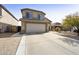 Two-story home with long driveway and a two car garage, in a desert landscape at 4439 E Coyote Wash Dr, Cave Creek, AZ 85331