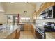 A spacious kitchen features granite countertops, wooden cabinets, and stainless steel appliances at 4439 E Coyote Wash Dr, Cave Creek, AZ 85331