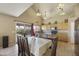 A dining room and kitchen combo showcases a large table with chairs under elegant pendant lighting at 4439 E Coyote Wash Dr, Cave Creek, AZ 85331