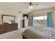 Bright bedroom features neutral colors, large window, and dark wood furniture, creating a serene and inviting atmosphere at 4439 E Coyote Wash Dr, Cave Creek, AZ 85331