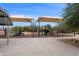 Community playground area featuring slides, climbing structures, and sun shades at 4439 E Coyote Wash Dr, Cave Creek, AZ 85331