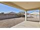 Covered patio with stone columns offers a shaded outdoor living space and view of the low-maintenance backyard at 454 N 19Th Pl, Coolidge, AZ 85128