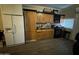 Kitchen featuring wooden cabinetry, black appliances, light-colored walls, and laminate flooring at 501 S 98Th St, Mesa, AZ 85208