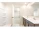 Bathroom featuring a dual sink vanity, shower, and neutral color palette at 5055 S 251St Dr, Buckeye, AZ 85326