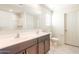 Bathroom with double vanity, tile floors, and a view of the shower at 5055 S 251St Dr, Buckeye, AZ 85326