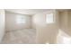 Well-lit bedroom featuring neutral carpet, white walls, and a large window, creating a serene atmosphere at 5055 S 251St Dr, Buckeye, AZ 85326