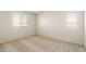 Bright bedroom with carpet, neutral walls, and two windows at 5055 S 251St Dr, Buckeye, AZ 85326