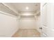 Walk-in closet with ample storage space and neutral carpet at 5055 S 251St Dr, Buckeye, AZ 85326