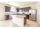 Contemporary kitchen showcasing granite counters, stainless steel appliances, and an island with seating at 5055 S 251St Dr, Buckeye, AZ 85326