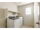 Laundry room with washer, dryer, shelf, and tiled floor at 5055 S 251St Dr, Buckeye, AZ 85326