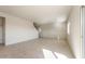 Bright living room featuring tile flooring, white walls, and natural light from a large window at 5055 S 251St Dr, Buckeye, AZ 85326