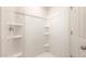 Clean and modern shower with built-in shelving at 5055 S 251St Dr, Buckeye, AZ 85326