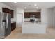 Modern kitchen featuring stainless steel appliances, a large island, and granite countertops at 5080 S 251St Dr, Buckeye, AZ 85326