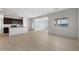 Bright living room showcasing tile flooring and an open floor plan to the kitchen at 5080 S 251St Dr, Buckeye, AZ 85326