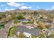 Aerial view of a neighborhood home surrounded by lush green lawns with mountain views at 5201 N 33Rd St, Phoenix, AZ 85018