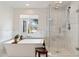 Bright bathroom features a soaking tub and a glass enclosed shower with marble tile at 5201 N 33Rd St, Phoenix, AZ 85018