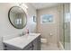 Bright bathroom features hexagon tile floors, modern vanity and mirror, and shower with glass door at 5201 N 33Rd St, Phoenix, AZ 85018