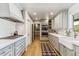 Stylish kitchen with stainless appliances and range, farmhouse sink, and wood floors at 5201 N 33Rd St, Phoenix, AZ 85018