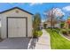 Backyard featuring a shed, well-maintained lawn, mature trees, and a stone pathway, adding functionality and charm at 5201 N 33Rd St, Phoenix, AZ 85018