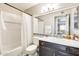 Well-lit bathroom features a shower-tub combo and a dark vanity with white sink at 540 N May -- # 2151, Mesa, AZ 85201