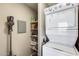 Convenient laundry area featuring a stacked washer and dryer unit and built-in storage shelves at 540 N May -- # 2151, Mesa, AZ 85201