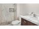 Contemporary bathroom features marble-style shower and vanity at 5902 W Wolf St, Phoenix, AZ 85033