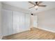 Bedroom with light wood floors and a closet with bi-fold doors at 5902 W Wolf St, Phoenix, AZ 85033