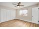 Neutral bedroom with light wood floors and a large window at 5902 W Wolf St, Phoenix, AZ 85033