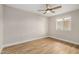 Light-filled bedroom featuring wood-look floors and neutral walls at 5902 W Wolf St, Phoenix, AZ 85033