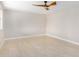 Bright, neutral bedroom with tile flooring, large window for ample sunlight, and modern ceiling fan at 5902 W Wolf St, Phoenix, AZ 85033