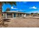 Lovely single-story home featuring an attached garage and a xeriscaped front yard, highlighted by a striking turquoise front door at 5902 W Wolf St, Phoenix, AZ 85033